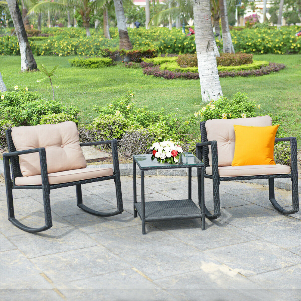 Beige 3-piece wicker rocking bistro set with glass coffee table and storage shelf, perfect for outdoor relaxation.