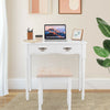 White vanity set with tri-fold mirror, cushioned stool, and four storage drawers for makeup organization.