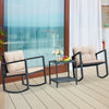 Two beige rocking chairs with cushions and a glass-top coffee table in a wicker bistro set for outdoor relaxation.