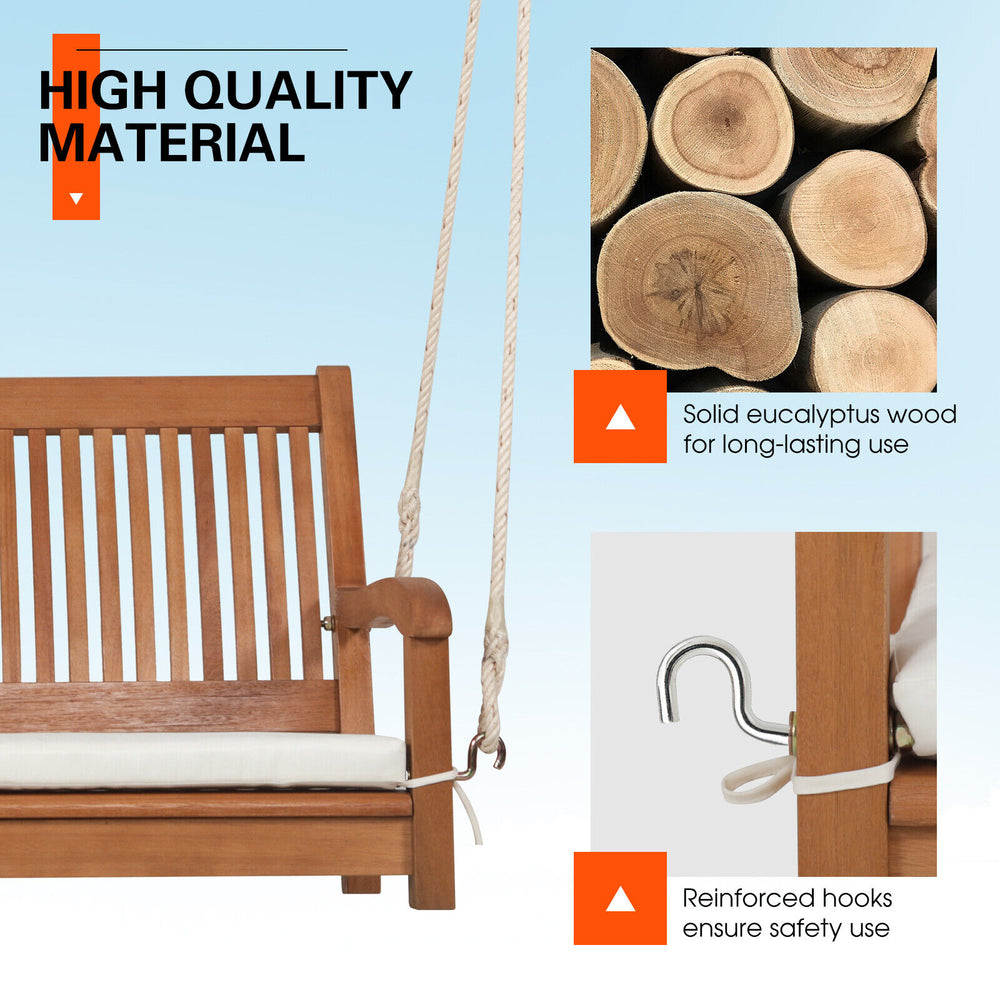 2-person hanging porch swing bench made of solid eucalyptus wood with cushion, ideal for backyard relaxation.