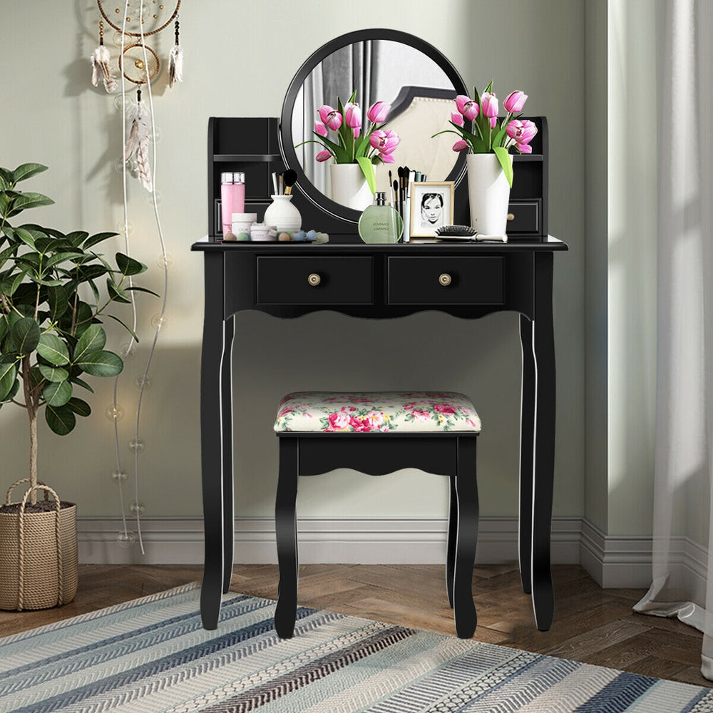 Detail view of the black makeup vanity table's 360-degree rotating mirror and spacious tabletop for easy access to.