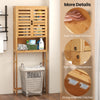 Bamboo over-the-toilet storage cabinet with adjustable shelf, double louvered doors, and ample bathroom storage space.