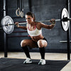 Weight lifting barbell with knurled handles, 1000 lbs capacity, ideal for various exercises in a gym setting.