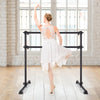 Ballet dancer practicing at a 4 feet adjustable black ballet barre, ideal for stretching and dance exercises.