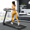 User running on the SuperFit 4.75HP folding treadmill with touch screen control in a modern bedroom setting.