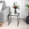 Square tempered glass side table with a sturdy metal frame, perfect for indoor or outdoor use, enhancing any space.