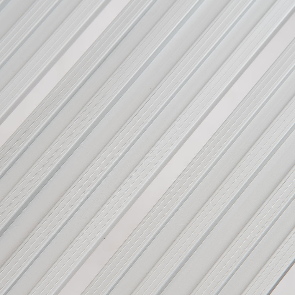 Close-up of the aluminum surface of a heavy-duty portable folding step ladder, designed for safety and stability.