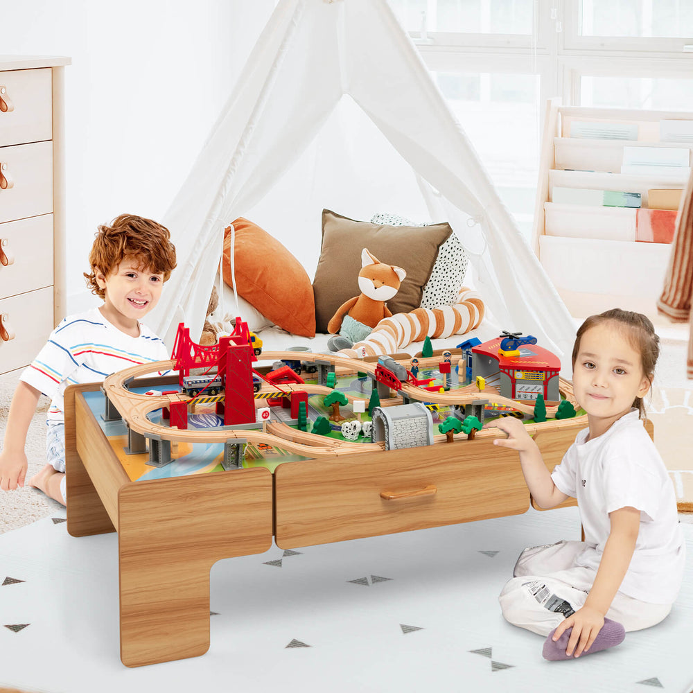Double-sided wooden train set table with 100 pieces, featuring storage drawer, for imaginative play and creativity.