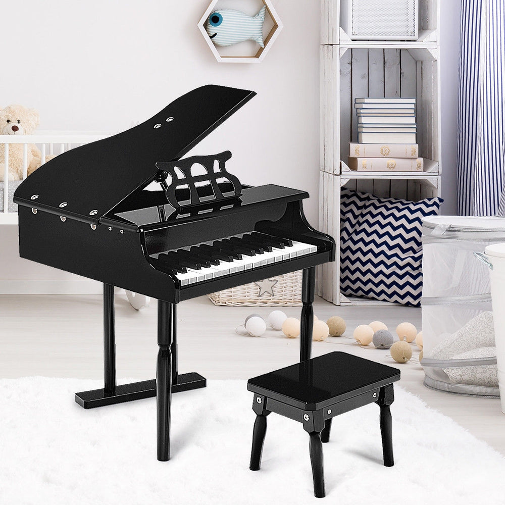 Mini grand piano toy in black with 30 keys, matching bench, and music score holder for children aged 1 to 7.
