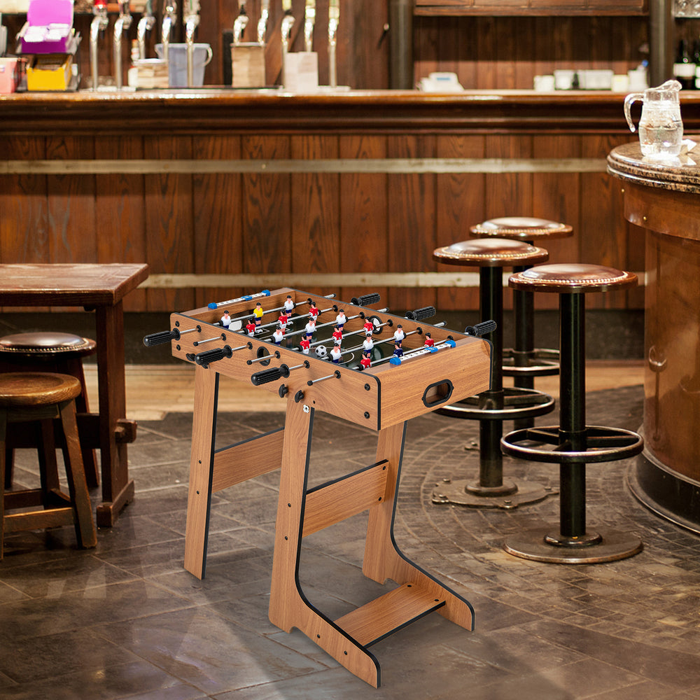 Foldable table football with durable handle, scoreboard, and two footballs, perfect for parties and group activities.