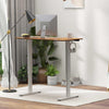 Compact standing desk with electric lift and ergonomic high-back chair, perfect for small home offices.
