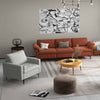 Stylish 3-seat sofa in orange with accent chair and floor lamp, perfect for modern living room decor.
