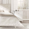 Nightstand with drawer and shelf in elegant curved design, perfect for bedside organization in a stylish bedroom.