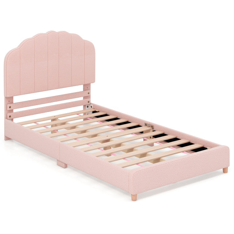 Twin pink bed with a scalloped headboard and sturdy wooden slats, perfect for a stylish children's room.