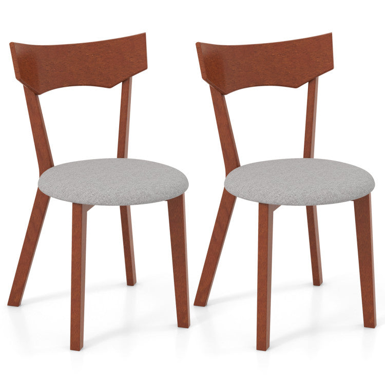 Set of two solid rubber wood dining chairs with soft padded cushions and ergonomic backrests for comfortable seating.