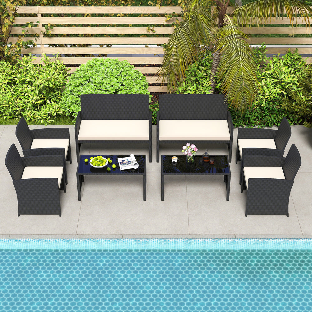 Stylish outdoor seating arrangement with two loveseats, six chairs, and a glass-top coffee table for patios or gardens.