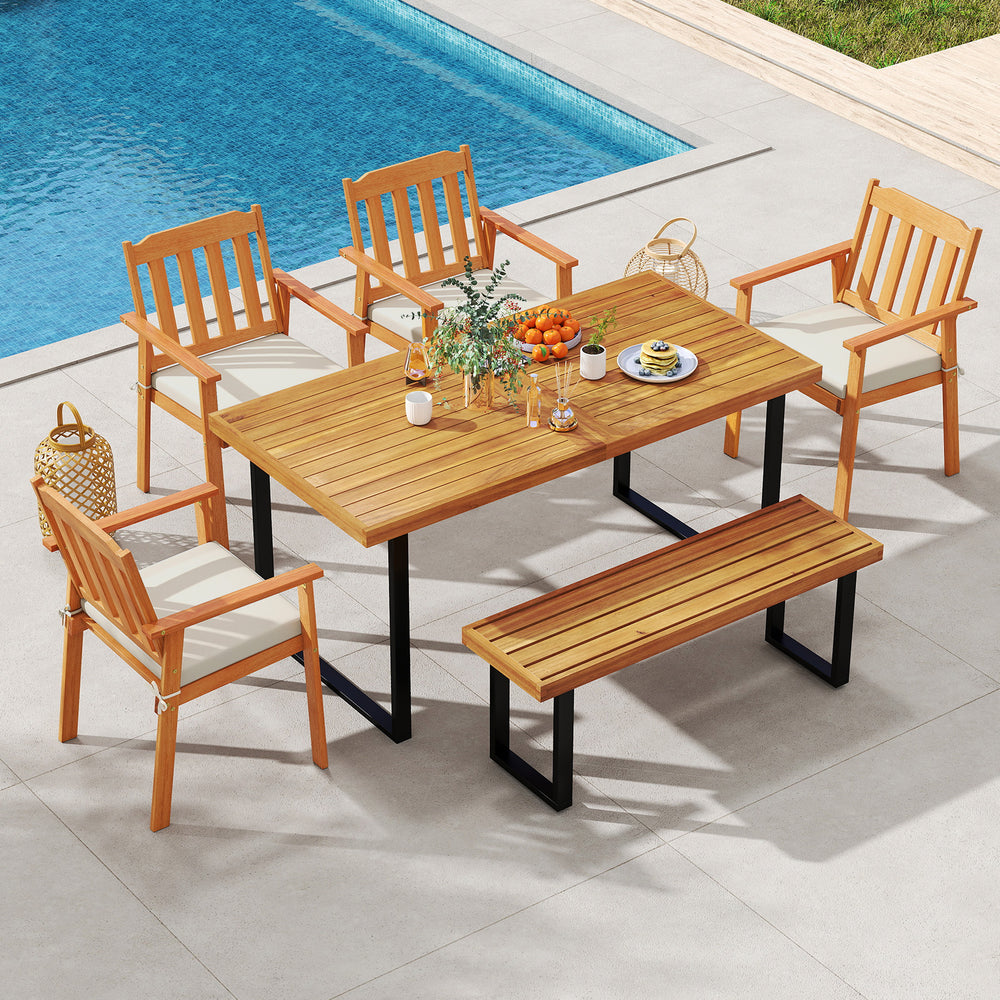 Patio dining set featuring a 63” acacia wood table, four armchairs, and a backless bench, perfect for outdoor.