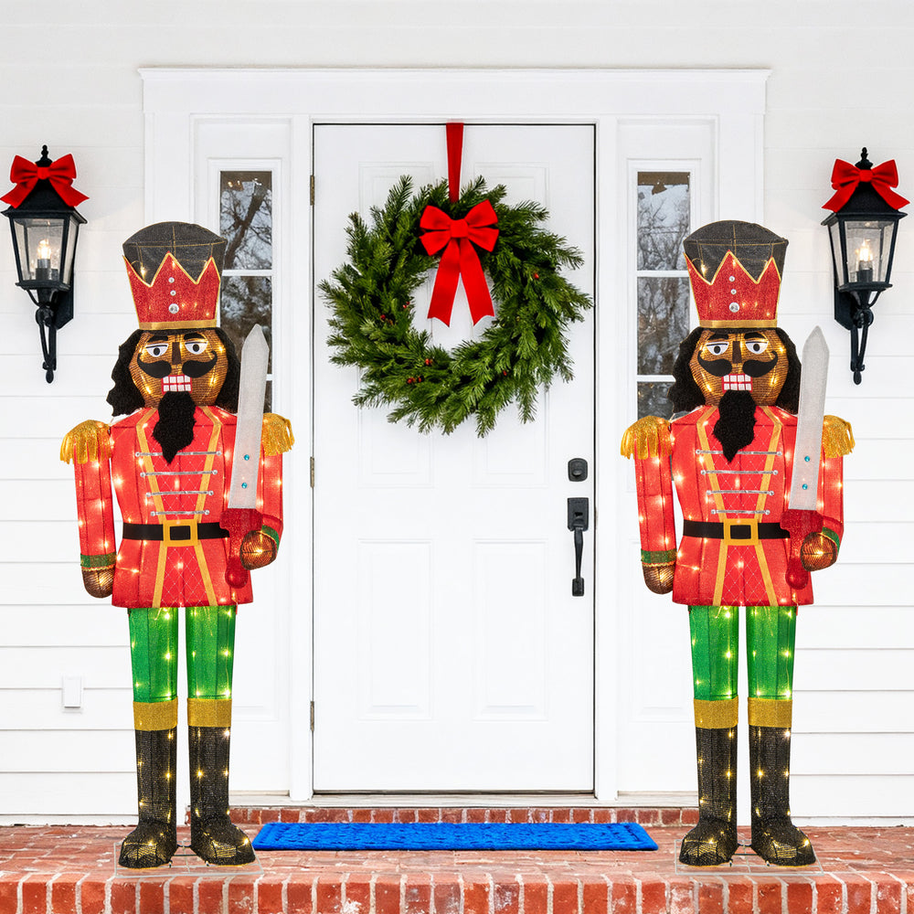 Set of 2 lighted 5 FT Christmas nutcrackers with glitter swords, featuring 100 warm-white LED lights for festive.