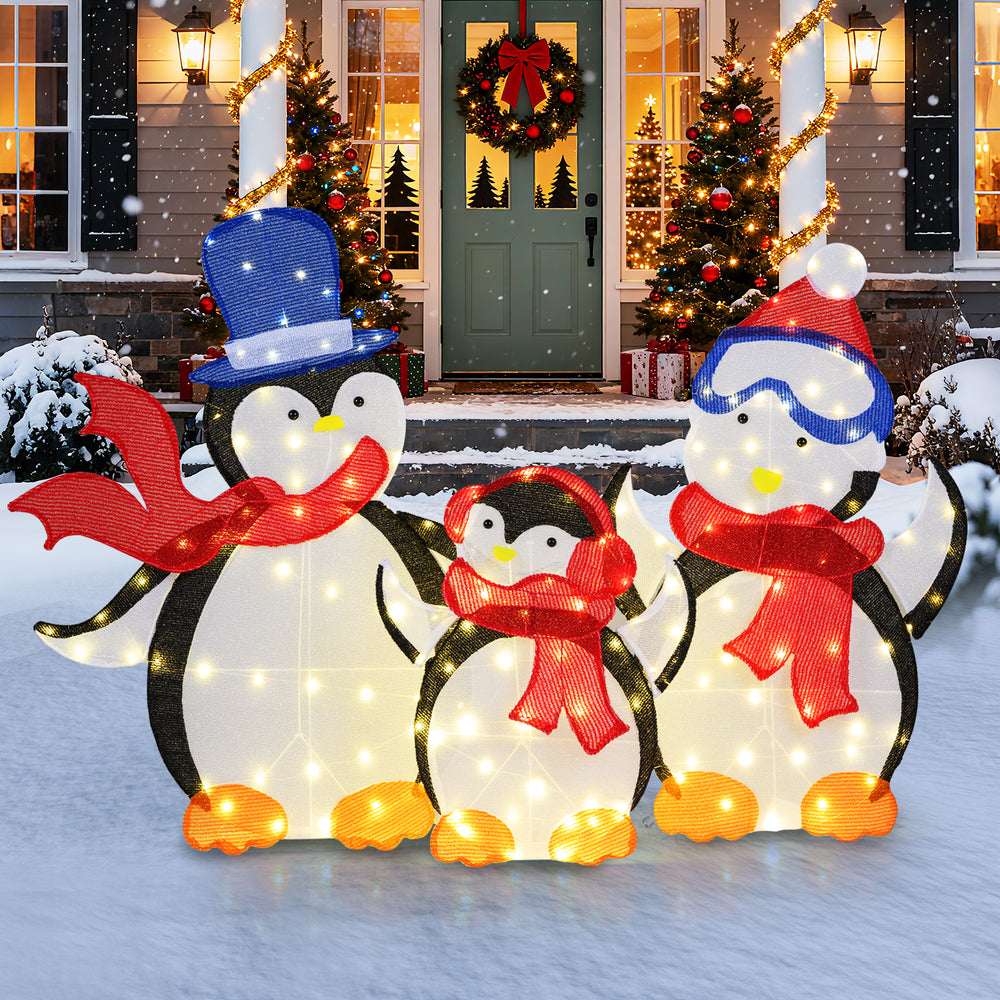 Lighted 3-piece penguin family Christmas decoration with 160 LED lights, featuring festive scarves for outdoor display.
