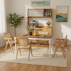 Extendable dining table with rattan accent chairs and kitchen cabinet, perfect for dining room or coffee bar area.