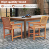 Two ergonomic wooden dining chairs with slatted surfaces beside a rectangular table, ideal for outdoor patio use.