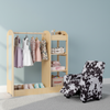 Kids recliner in black & white beside natural dress-up storage with clothes, perfect for a child's room setup.