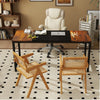 Two rattan accent chairs with bamboo frames in a home office setup featuring a spacious desk and ergonomic chair.