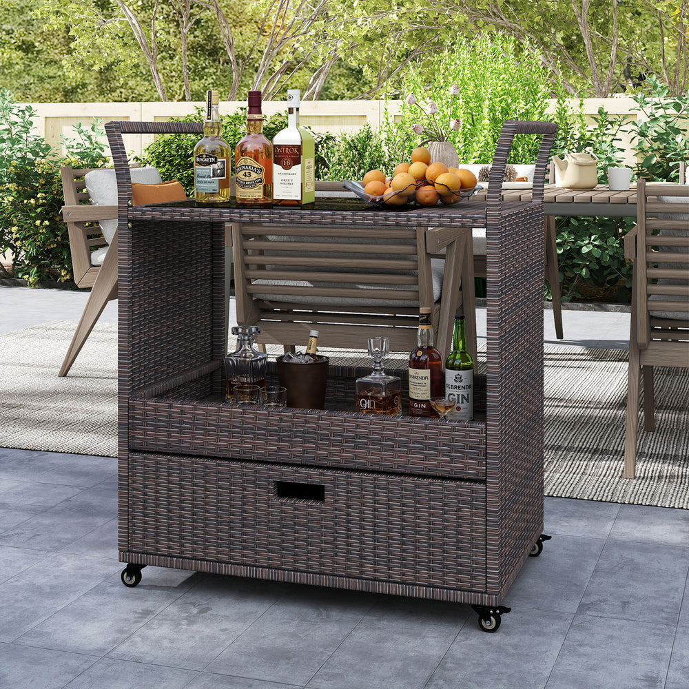 Outdoor wicker bar cart table with tempered glass top, featuring a spacious shelf and drawer, ideal for patio or garden.