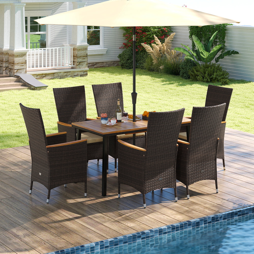 Outdoor dining set for 6 featuring wicker armchairs and an acacia wood table, perfect for patio gatherings.