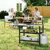 Outdoor foldable grill table with flip-up top, storage shelves, and sturdy frame, perfect for backyard grilling.