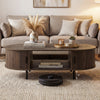 Oval coffee table with walnut finish, featuring dual side shelves and fluted door accents for a stylish living room.