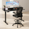Electric height adjustable standing desk with sleek design and built-in drawers, paired with ergonomic drafting chair.