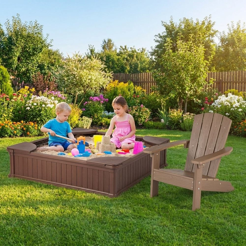 Kids playing in a large sandbox with cover and two Adirondack chairs, perfect for outdoor fun and relaxation.