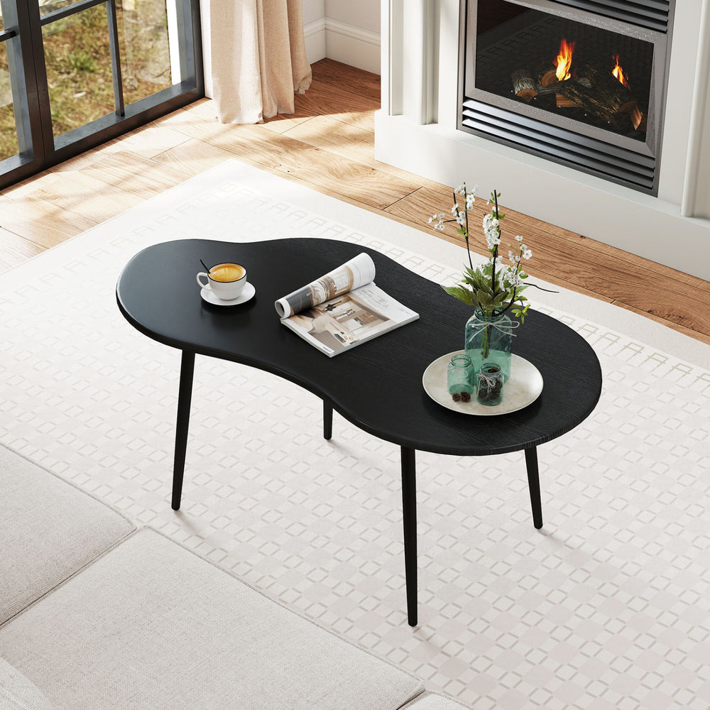 Cloud shape coffee table with black metal frame, featuring a wide tabletop and elegant curves, perfect for living room.