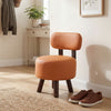 Round orange ottoman with backrest, featuring faux leather and rubber wood legs, perfect for living rooms or entryways.