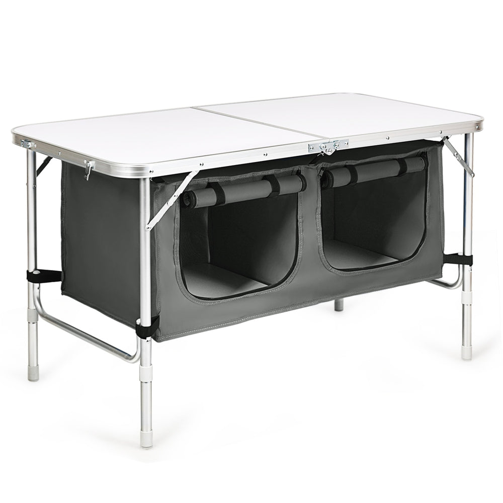 Foldable camping table with storage compartments, designed for outdoor use, perfect for camping and picnics.