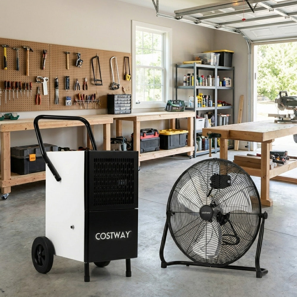 Commercial dehumidifier and heavy-duty metal floor fan combo in a garage setting, ideal for moisture control and.