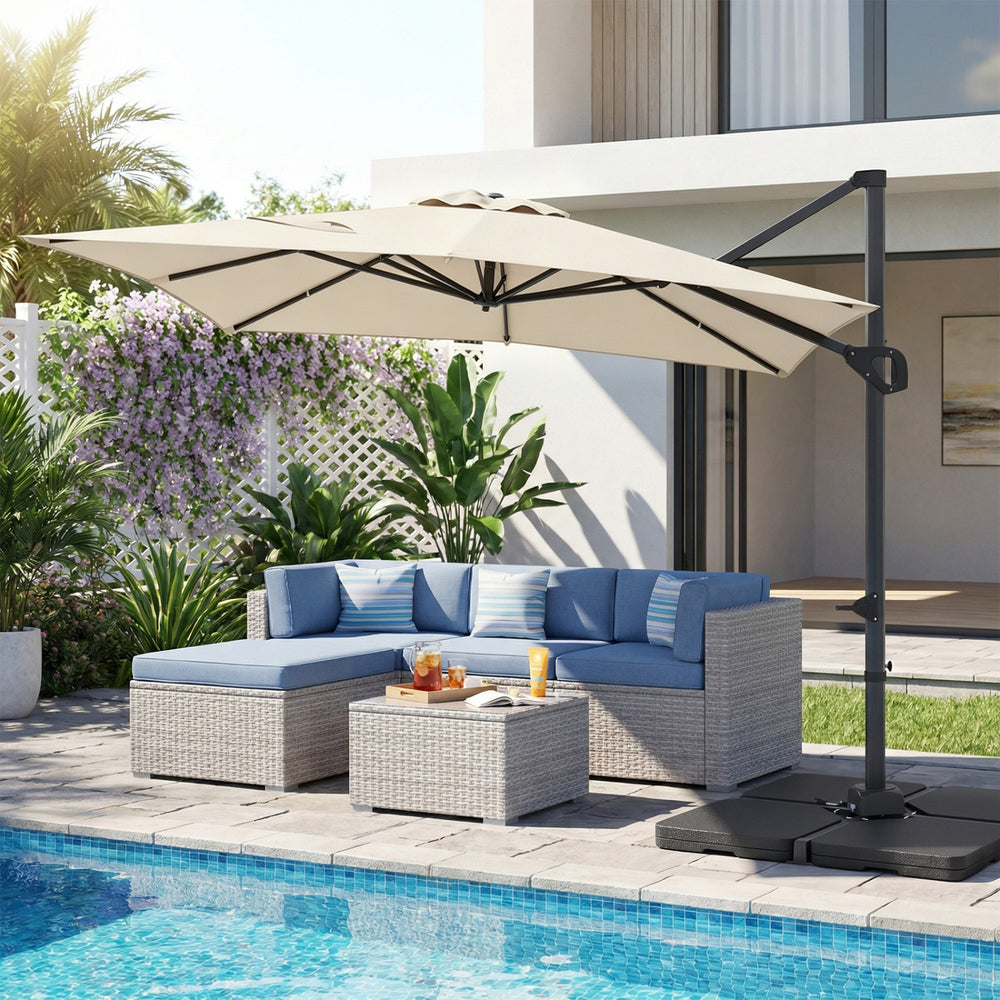 Beige 11 x 9 FT outdoor offset hanging umbrella with aluminum pole, positioned beside a patio sofa set by the pool.