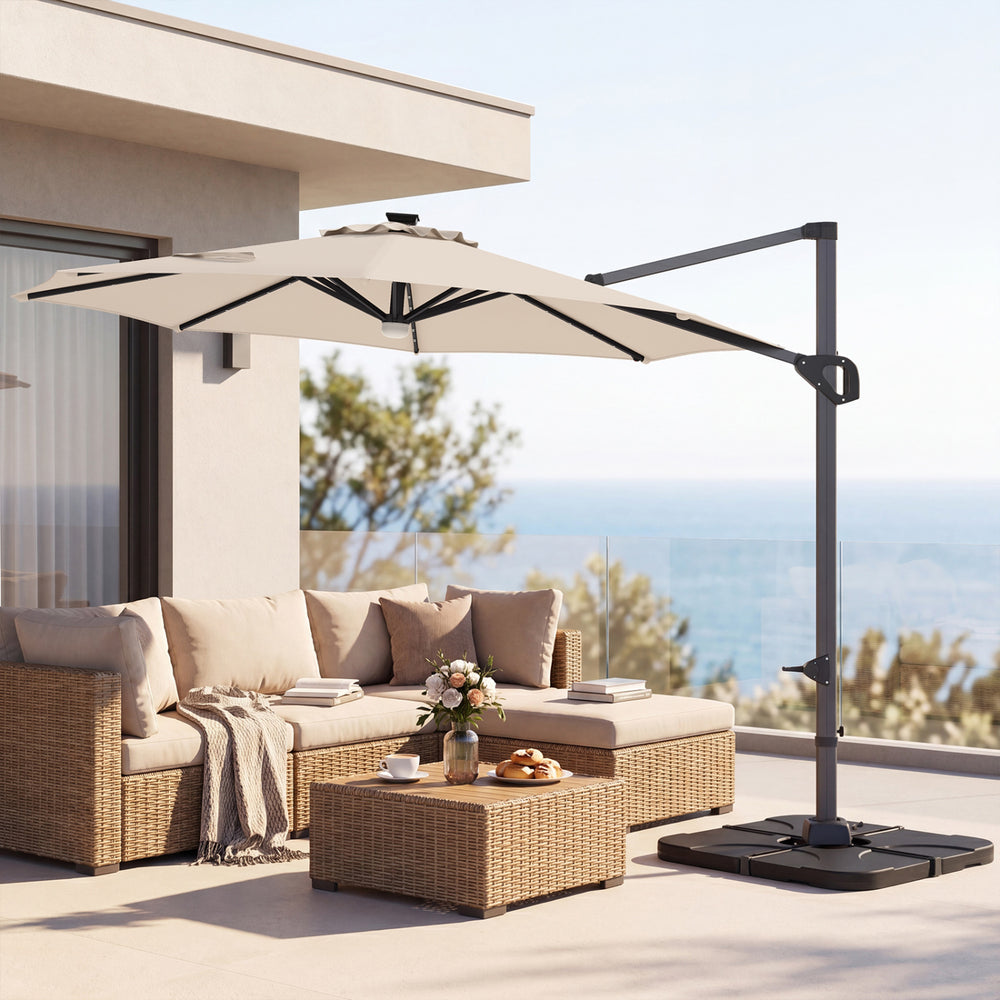10 FT cantilever patio umbrella in beige with solar LED lights, positioned over a rattan sofa set for outdoor.