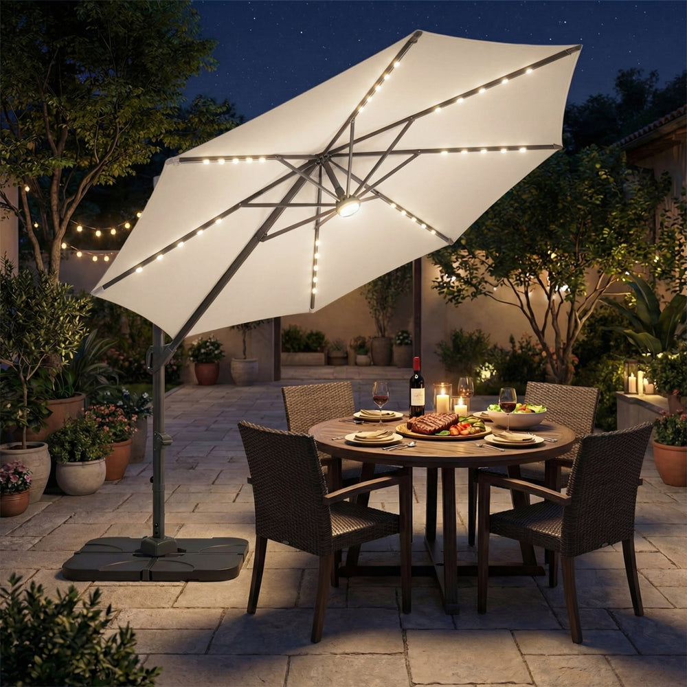 10 FT cantilever patio umbrella with solar LED lights, beige, providing shade for outdoor dining table at night.