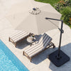 Beige 10 FT cantilever patio umbrella with solar LED lights, positioned over two lounge chairs by the poolside.
