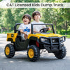 Two kids enjoying a ride in the yellow 24V licensed CAT dump truck, perfect for outdoor fun and adventure.