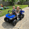 Two children enjoying a ride in a blue 24V kids ride-on dump truck with electric dump bed, perfect for outdoor fun.