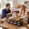 Couple enjoying a meal with the 2-in-1 Table Grill and Griddle, featuring a reversible nonstick plate for 8.