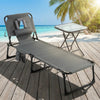 Folding lounge chair with adjustable backrest and side table, perfect for sunbathing and outdoor relaxation.