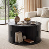 Round black coffee table with storage, fluted design, and sliding tambour door for organized living room decor.