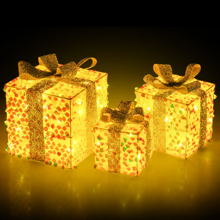 Three lighted gift boxes with bows, featuring warm white LEDs, perfect for enhancing holiday living room decor.