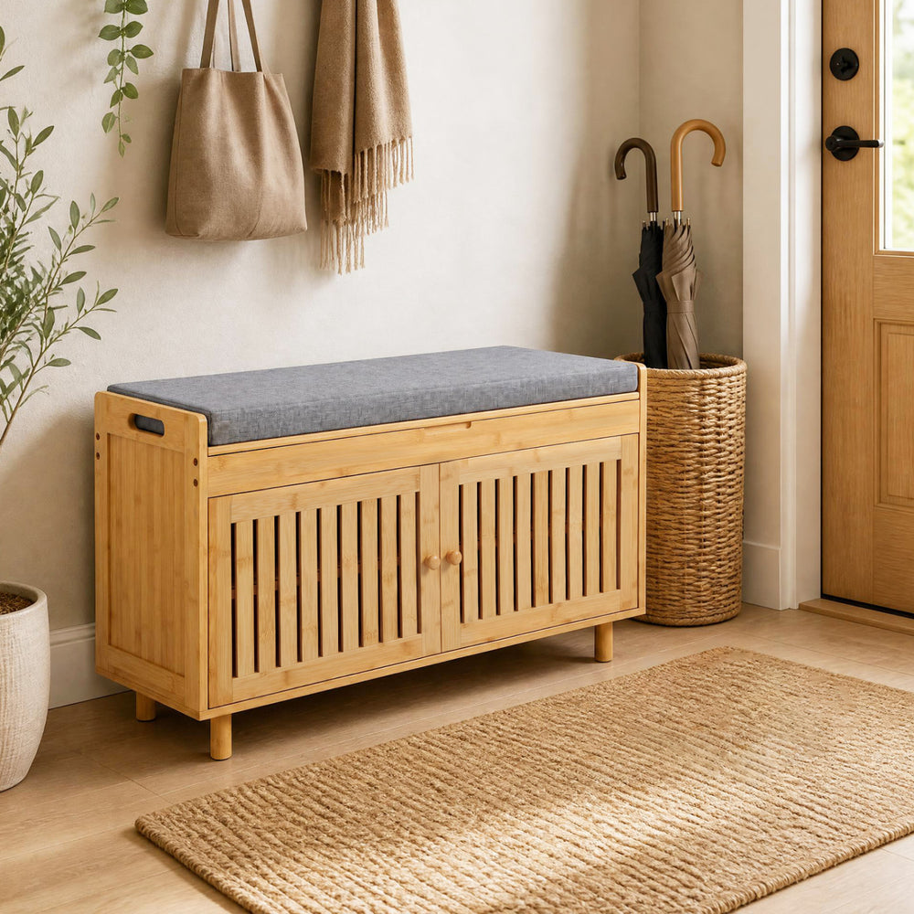 Bamboo shoe storage bench with lift top, removable cushion, and two-door cabinet for hallway organization.