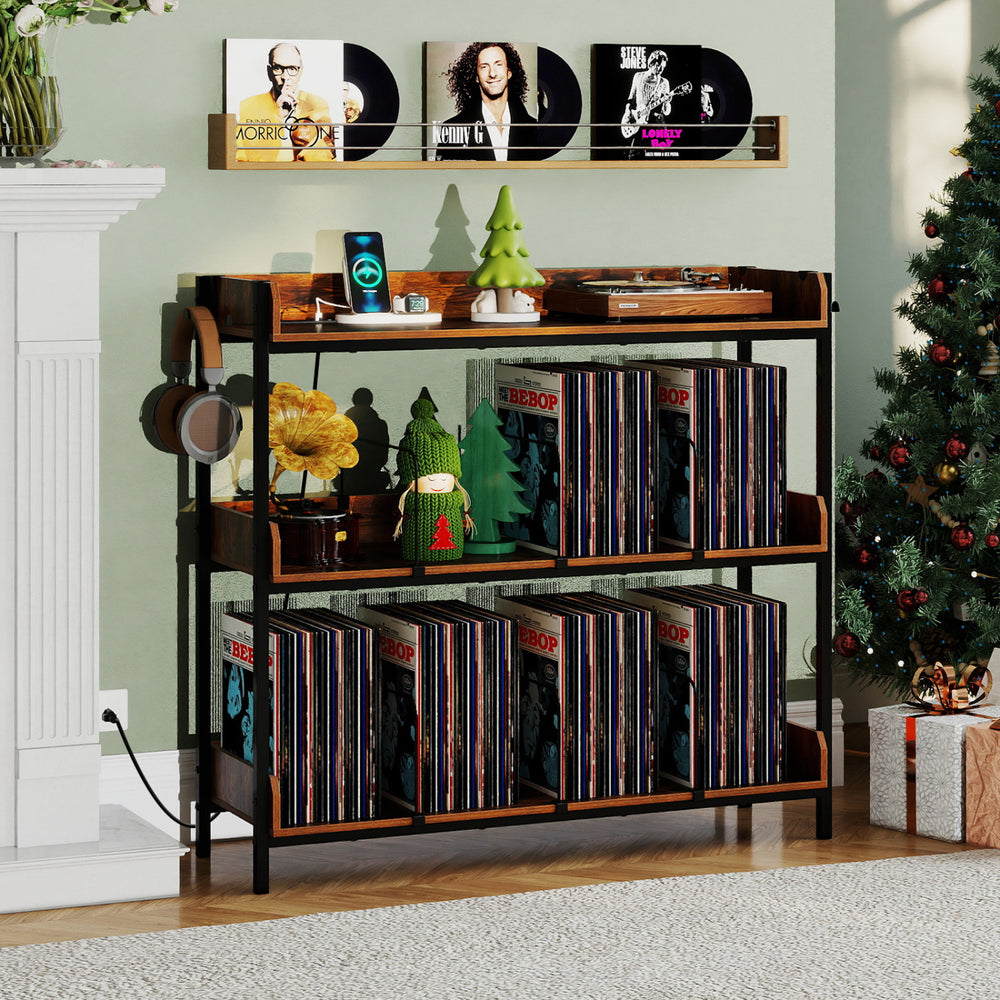 3-tier record player stand in rustic brown with metal dividers, holding vinyl records and featuring power outlets for convenience.