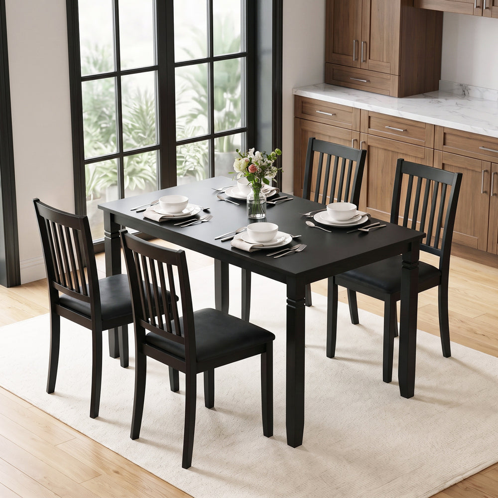 Black 48" rectangular kitchen table with solid rubber wood legs, seating four comfortably, featuring rounded corners and elegant detailing.
